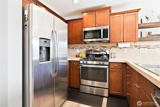 6672 Udall Pl SE, Auburn, WA 98092 - kitchen with appliances with stainless steel finishes, open shelves, light countertops, brown cabinets, and decorative backsplash
