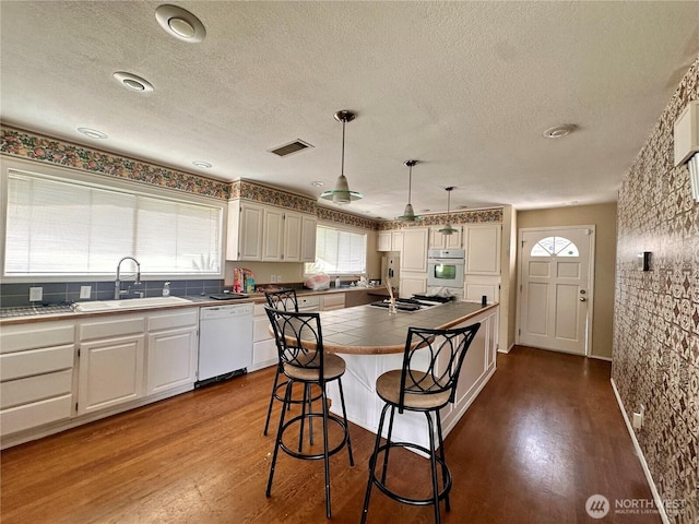 1445 SW 296th St, Federal Way, WA 98023 - kitchen featuring white dishwasher, oven, tile countertops, dark wood-style flooring, and a textured ceiling