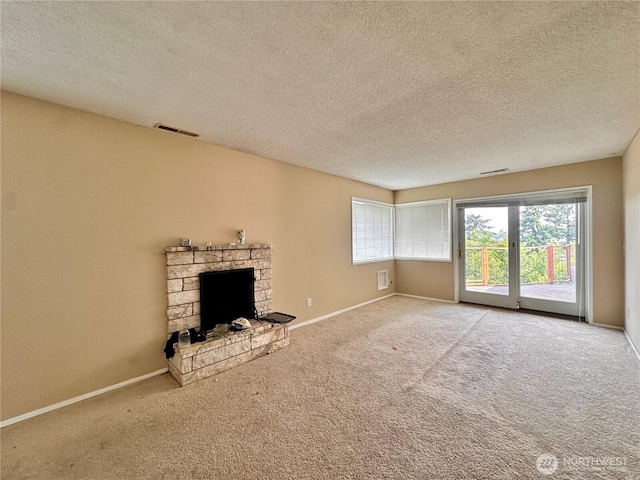 1445 SW 296th St, Federal Way, WA 98023 - unfurnished living room with carpet flooring, a textured ceiling, and a stone fireplace