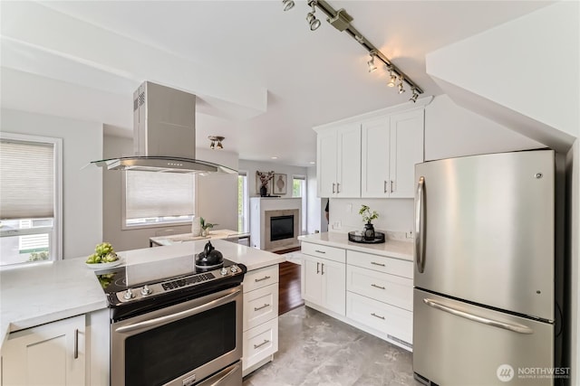 2801 NE 130th St Unit C101, Seattle, WA 98125 - kitchen with stainless steel appliances, island exhaust hood, light countertops, white cabinets, and plenty of natural light