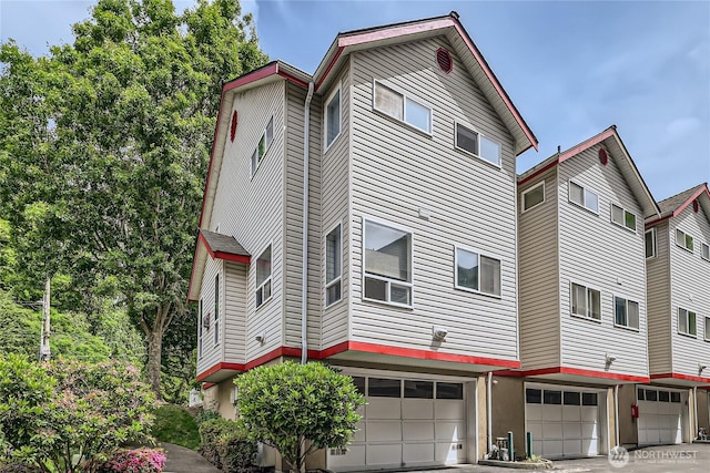 2801 NE 130th St Unit C101, Seattle, WA 98125 - view of building exterior with a garage