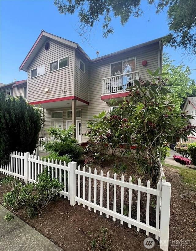 2801 NE 130th St Unit C101, Seattle, WA 98125 - view of front of home featuring a fenced front yard and a balcony