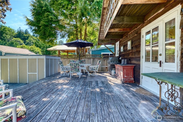 2111 Maple St, Point Roberts, WA 98281 - wooden deck with outdoor dining space, grilling area, a fenced backyard, and french doors