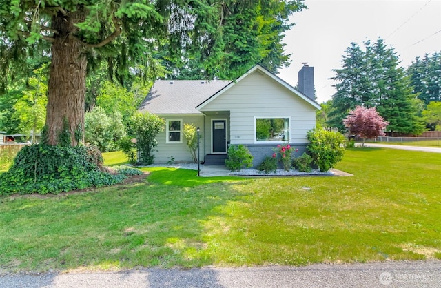 318 Mill Ave SE, Orting, WA 98360 - view of front of house with a chimney and a front lawn