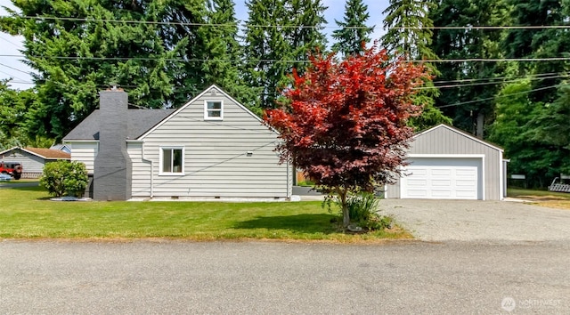 318 Mill Ave SE, Orting, WA 98360 - view of side of property with a detached garage, a chimney, a yard, and crawl space