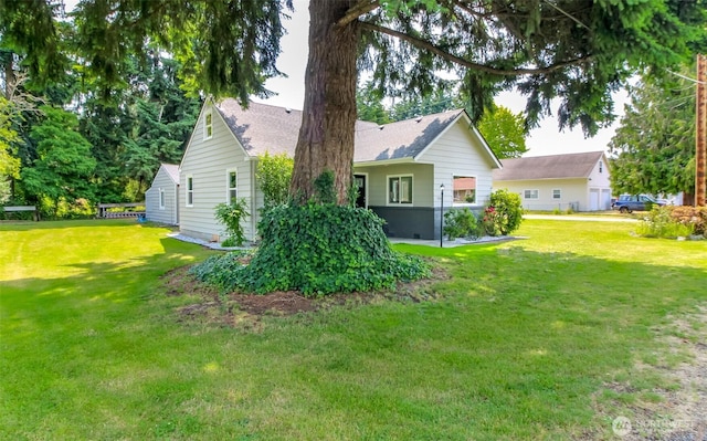 318 Mill Ave SE, Orting, WA 98360 - rear view of property with a lawn and a shingled roof