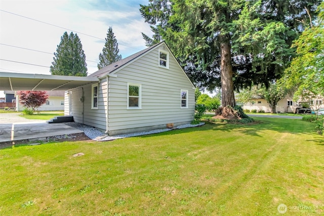 318 Mill Ave SE, Orting, WA 98360 - view of property exterior featuring an attached carport, a yard, and concrete driveway