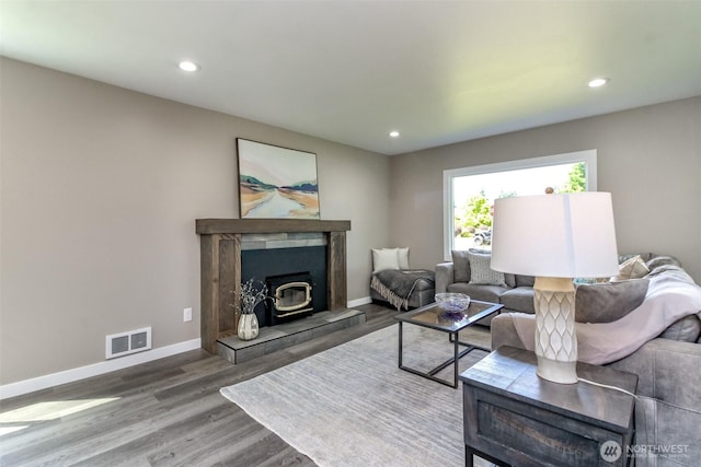 318 Mill Ave SE, Orting, WA 98360 - living area featuring wood finished floors, recessed lighting, and a wood stove