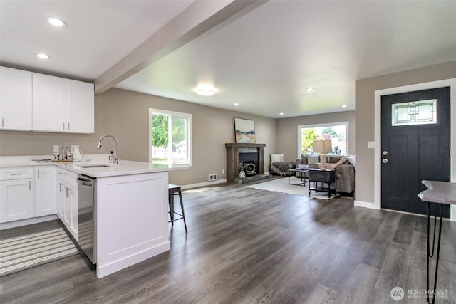 318 Mill Ave SE, Orting, WA 98360 - kitchen with a peninsula, white cabinetry, healthy amount of natural light, dark wood finished floors, and recessed lighting