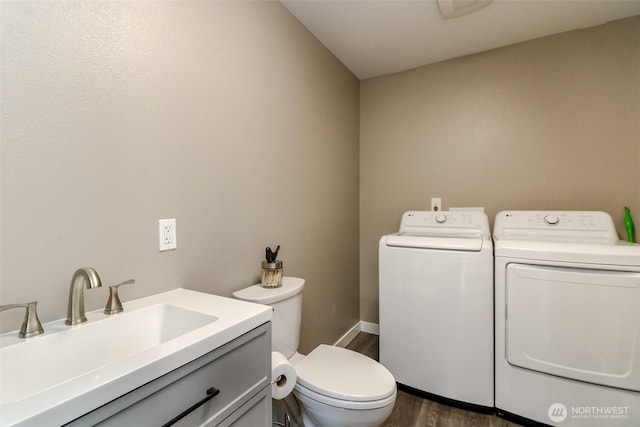 318 Mill Ave SE, Orting, WA 98360 - half bath with washer and clothes dryer, wood finished floors, and vanity