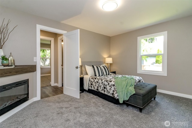 318 Mill Ave SE, Orting, WA 98360 - carpeted bedroom with multiple windows and a glass covered fireplace