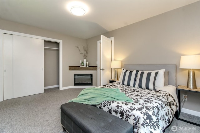 318 Mill Ave SE, Orting, WA 98360 - carpeted bedroom featuring a closet and a glass covered fireplace