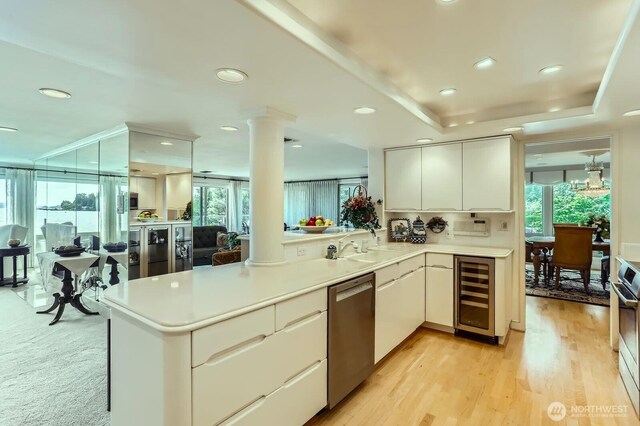 9727 NE Juanita Dr Unit 201, Kirkland, WA 98034 - kitchen featuring wine cooler, dishwasher, healthy amount of natural light, ornate columns, and recessed lighting