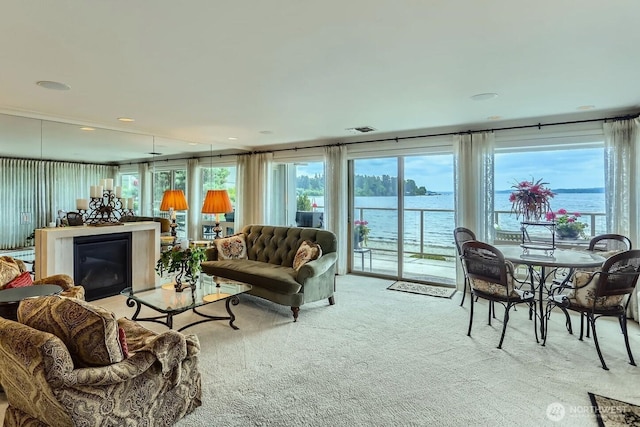 9727 NE Juanita Dr Unit 201, Kirkland, WA 98034 - carpeted living area with a water view and a glass covered fireplace