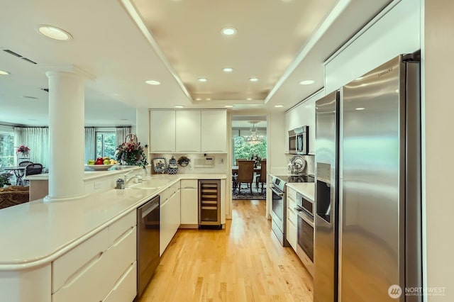 9727 NE Juanita Dr Unit 201, Kirkland, WA 98034 - kitchen with stainless steel appliances, wine cooler, healthy amount of natural light, a peninsula, and recessed lighting