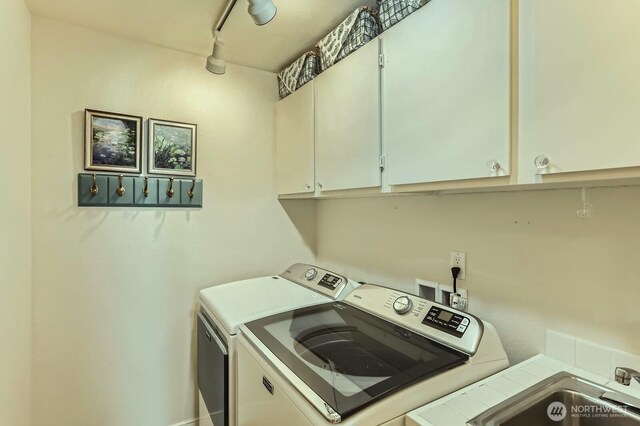 9727 NE Juanita Dr Unit 201, Kirkland, WA 98034 - washroom featuring washer and dryer and cabinet space