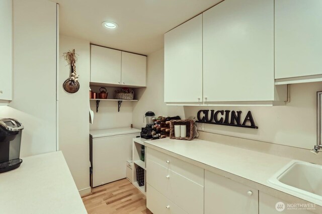 9727 NE Juanita Dr Unit 201, Kirkland, WA 98034 - kitchen with light wood-style floors, light countertops, recessed lighting, open shelves, and refrigerator