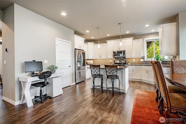 5417 Ocean Mist Loop, Blaine, WA 98230 - kitchen with stainless steel appliances, dark wood finished floors, backsplash, white cabinets, and an office area