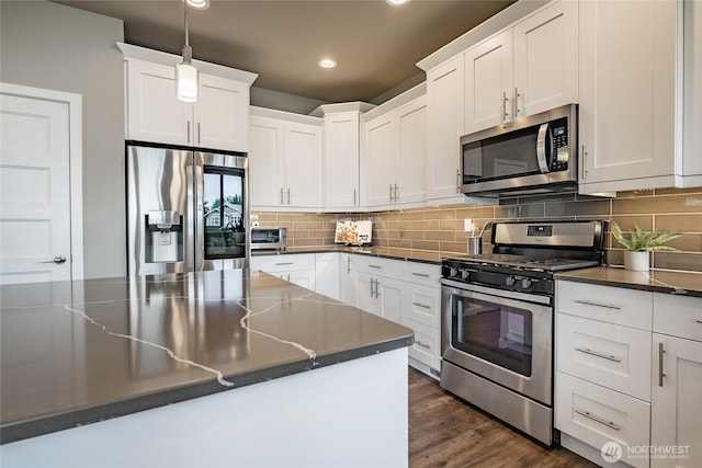 5417 Ocean Mist Loop, Blaine, WA 98230 - kitchen featuring stainless steel appliances, dark countertops, recessed lighting, white cabinetry, and decorative backsplash