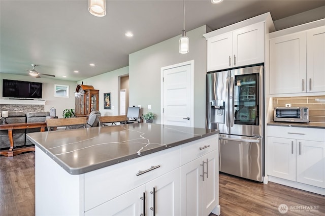 5417 Ocean Mist Loop, Blaine, WA 98230 - kitchen with stainless steel fridge with ice dispenser, a center island, recessed lighting, wood finished floors, and white cabinets