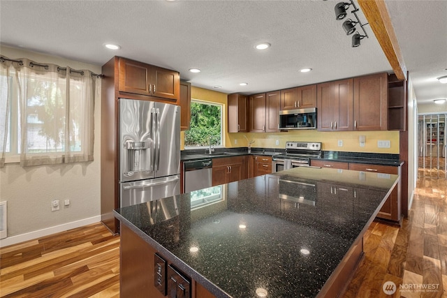 118 W Winesap Rd, Bothell, WA 98012 - kitchen with appliances with stainless steel finishes, wood finished floors, open shelves, recessed lighting, and dark stone countertops