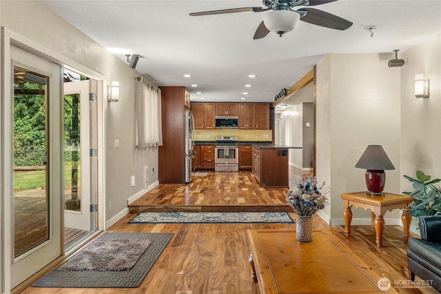 118 W Winesap Rd, Bothell, WA 98012 - kitchen with appliances with stainless steel finishes, dark countertops, ceiling fan, recessed lighting, and open floor plan