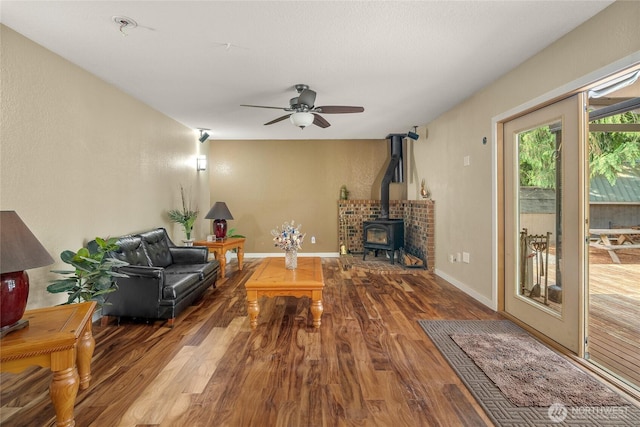 118 W Winesap Rd, Bothell, WA 98012 - living area featuring wood finished floors, a wood stove, and a ceiling fan