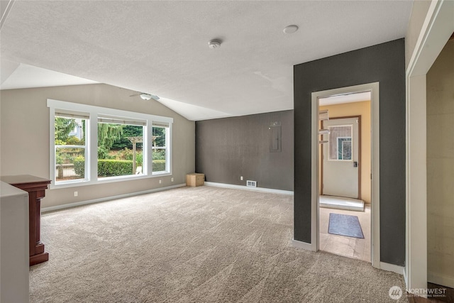 118 W Winesap Rd, Bothell, WA 98012 - unfurnished living room with carpet floors, vaulted ceiling, a textured ceiling, and a ceiling fan