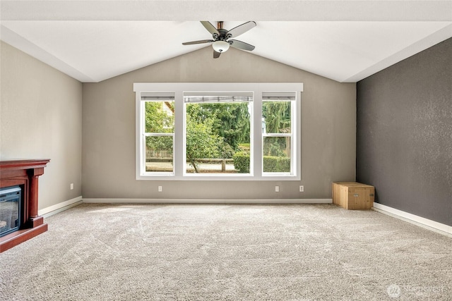 118 W Winesap Rd, Bothell, WA 98012 - unfurnished living room featuring healthy amount of natural light, ceiling fan, carpet, vaulted ceiling, and a glass covered fireplace