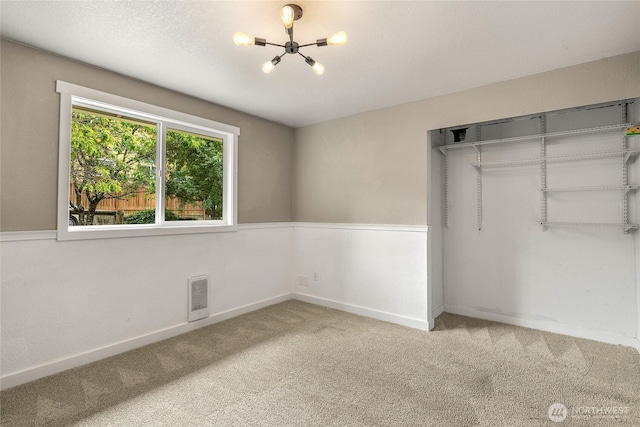 118 W Winesap Rd, Bothell, WA 98012 - unfurnished bedroom featuring a chandelier, carpet flooring, and a closet