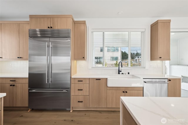 8517 137th Ave SE Unit 1, Newcastle, WA 98059 - kitchen with stainless steel appliances, light brown cabinets, backsplash, light wood finished floors, and light stone counters