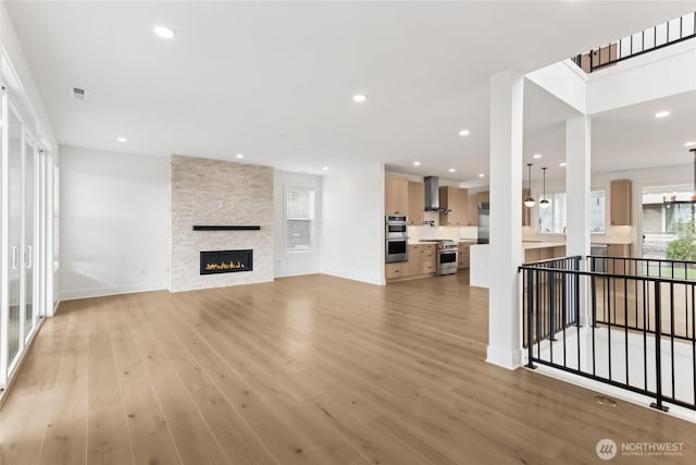 8517 137th Ave SE Unit 1, Newcastle, WA 98059 - unfurnished living room featuring light wood finished floors, a fireplace, and recessed lighting