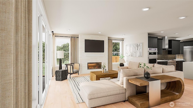 8517 137th Ave SE Unit 1, Newcastle, WA 98059 - living area with healthy amount of natural light, light wood-style floors, a fireplace, and recessed lighting