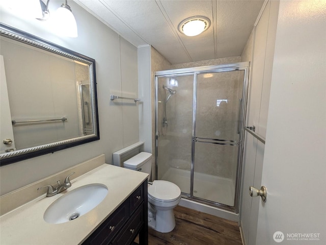 201 Union Ave SE Unit 92, Renton, WA 98059 - bathroom featuring wood finished floors, a shower stall, vanity, and a textured ceiling