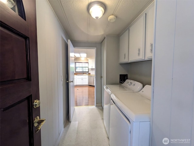 201 Union Ave SE Unit 92, Renton, WA 98059 - laundry area with cabinet space, washing machine and clothes dryer, and light flooring