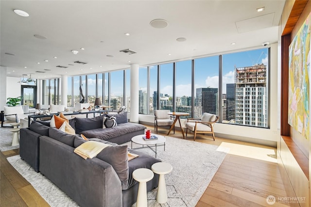 2510 6th Ave Unit 1010, Seattle, WA 98121 - living area with a skyline view, hardwood / wood-style flooring, and a wall of windows
