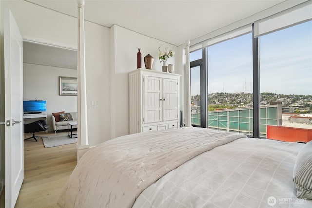 2510 6th Ave Unit 1010, Seattle, WA 98121 - bedroom with a wall of windows and wood finished floors