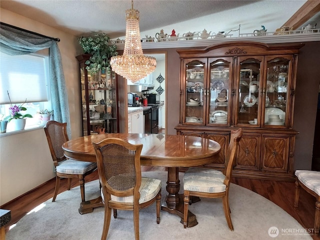 8430 15th Pl SE Unit 33, Lake Stevens, WA 98258 - dining area with a chandelier, light wood-type flooring, and a textured ceiling
