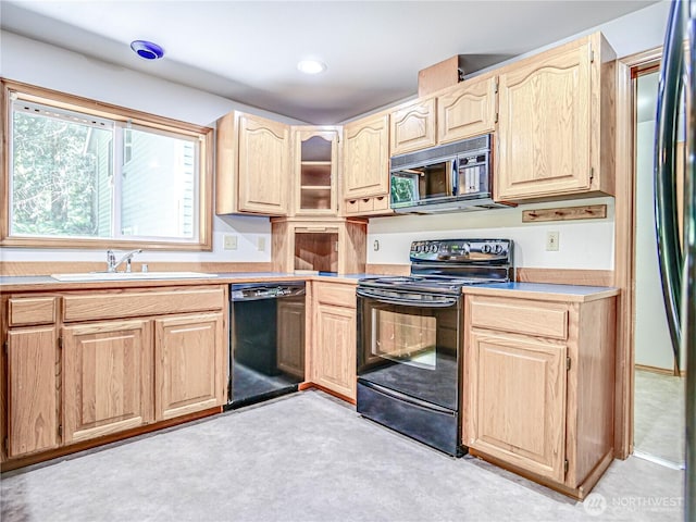 4616 140th St NW, Marysville, WA 98271 - kitchen with black appliances, light brown cabinetry, light countertops, light colored carpet, and glass insert cabinets