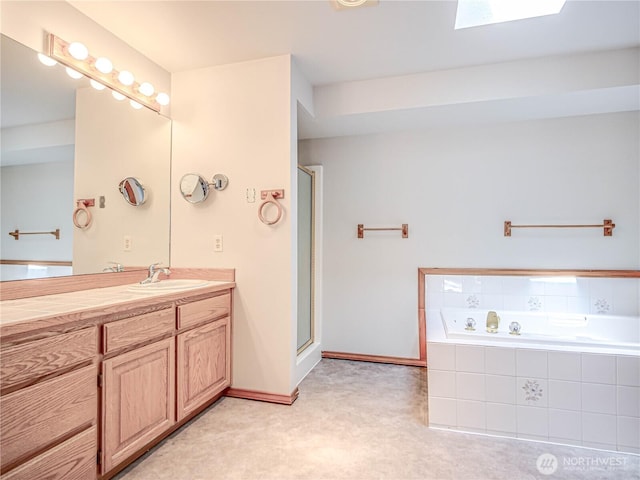4616 140th St NW, Marysville, WA 98271 - bathroom with vanity, a garden tub, a shower with door, and a skylight