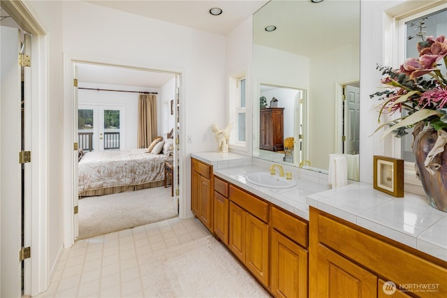 33571 Cliff Rd, Mount Vernon, WA 98274 - ensuite bathroom with french doors, vanity, and tile patterned floors