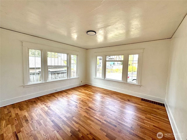 608 N Puget Sound Ave, Tacoma, WA 98406 - spare room with healthy amount of natural light and wood finished floors