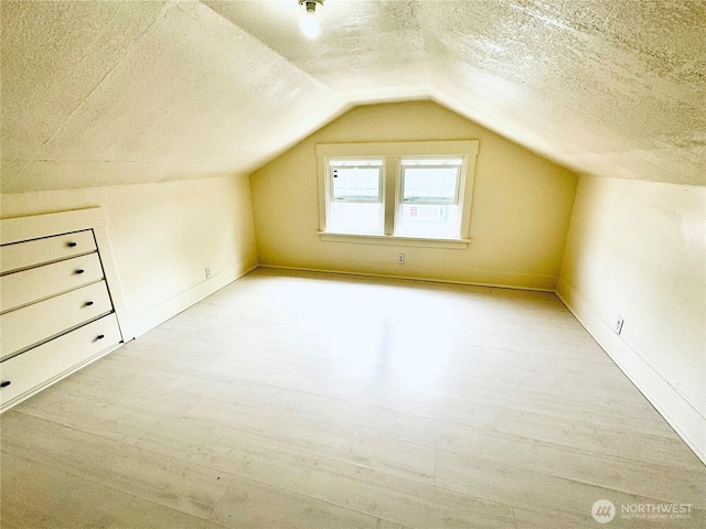608 N Puget Sound Ave, Tacoma, WA 98406 - additional living space featuring light wood-style floors, a textured ceiling, and lofted ceiling