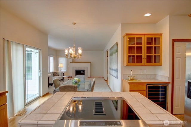 1218 Alpine View Dr, Mount Vernon, WA 98274 - kitchen with wine cooler, tile countertops, a fireplace, glass insert cabinets, and recessed lighting