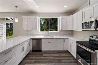 11020 Matthews Way, Anderson Island, WA 98303 - kitchen with appliances with stainless steel finishes, white cabinetry, dark wood-style floors, pendant lighting, and recessed lighting