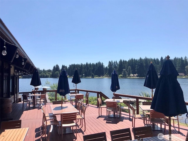 11020 Matthews Way, Anderson Island, WA 98303 - deck featuring outdoor dining area, a forest view, and a water view