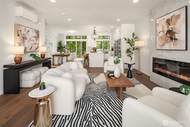 19722 Filbert Dr Unit A-4, Bothell, WA 98012 - living room featuring a wall mounted AC, wood finished floors, a fireplace, recessed lighting, and a chandelier