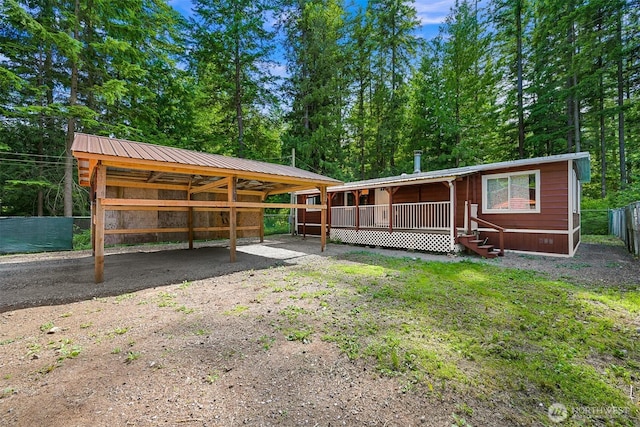 8283 Golden Valley Blvd, Maple Falls, WA 98266 - view of front of house featuring a metal roof and a carport