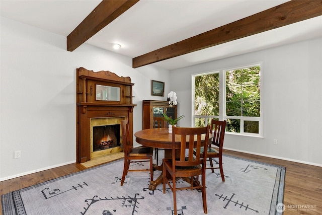 24016 SE 111th St, Issaquah, WA 98027 - dining room with a fireplace, beam ceiling, and wood finished floors