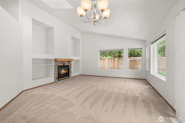 5221 Ivy Hill Ln SE, Lacey, WA 98513 - unfurnished living room featuring lofted ceiling, a chandelier, carpet floors, a stone fireplace, and built in features